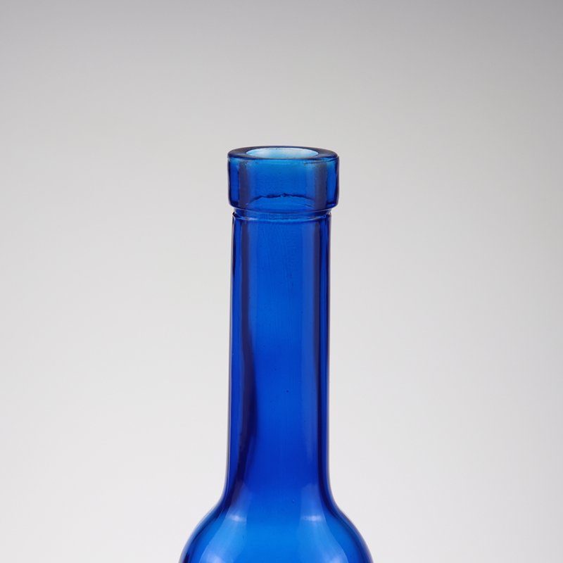 Low price and MOQ Drop shape cobalt blue spirit glass bottle fruit wine bottle tall thin beverage bottle