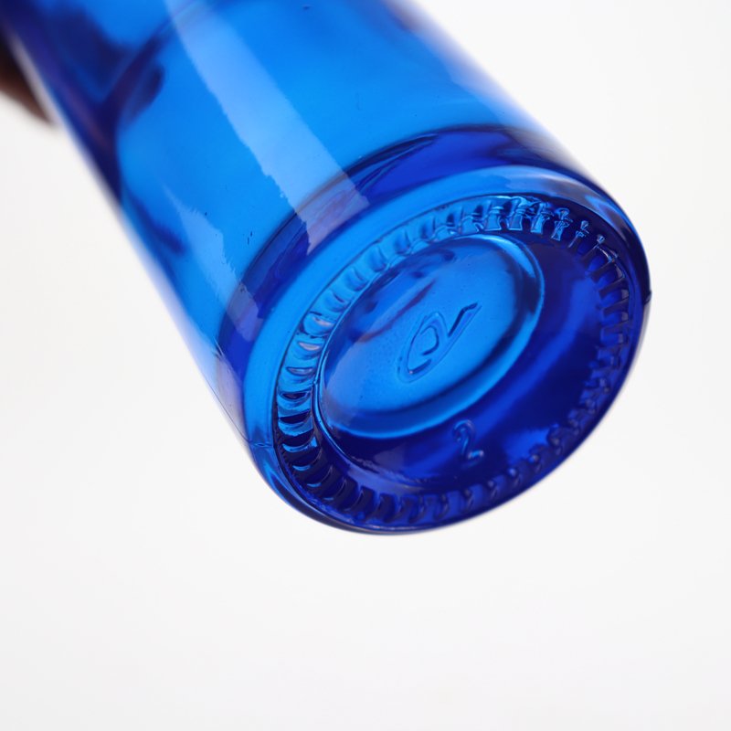 Low price and MOQ Drop shape cobalt blue spirit glass bottle fruit wine bottle tall thin beverage bottle