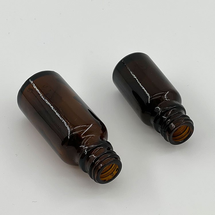 Wholesale custom 10ml 15ml 30ml 100ml amber round serum bottle glass essential oil bottle with dropper