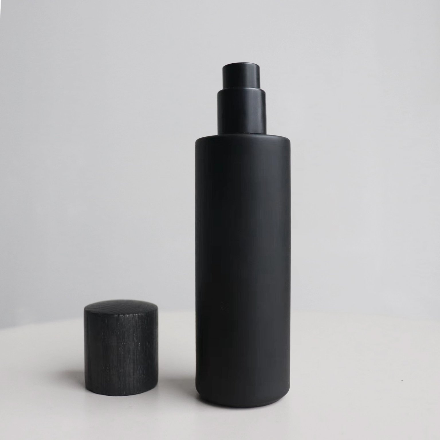 High Quality 30ml Cylinder Slim Crimp Neck Thick Bottom Perfume Glass Spray Bottle With Black Wooden Cap