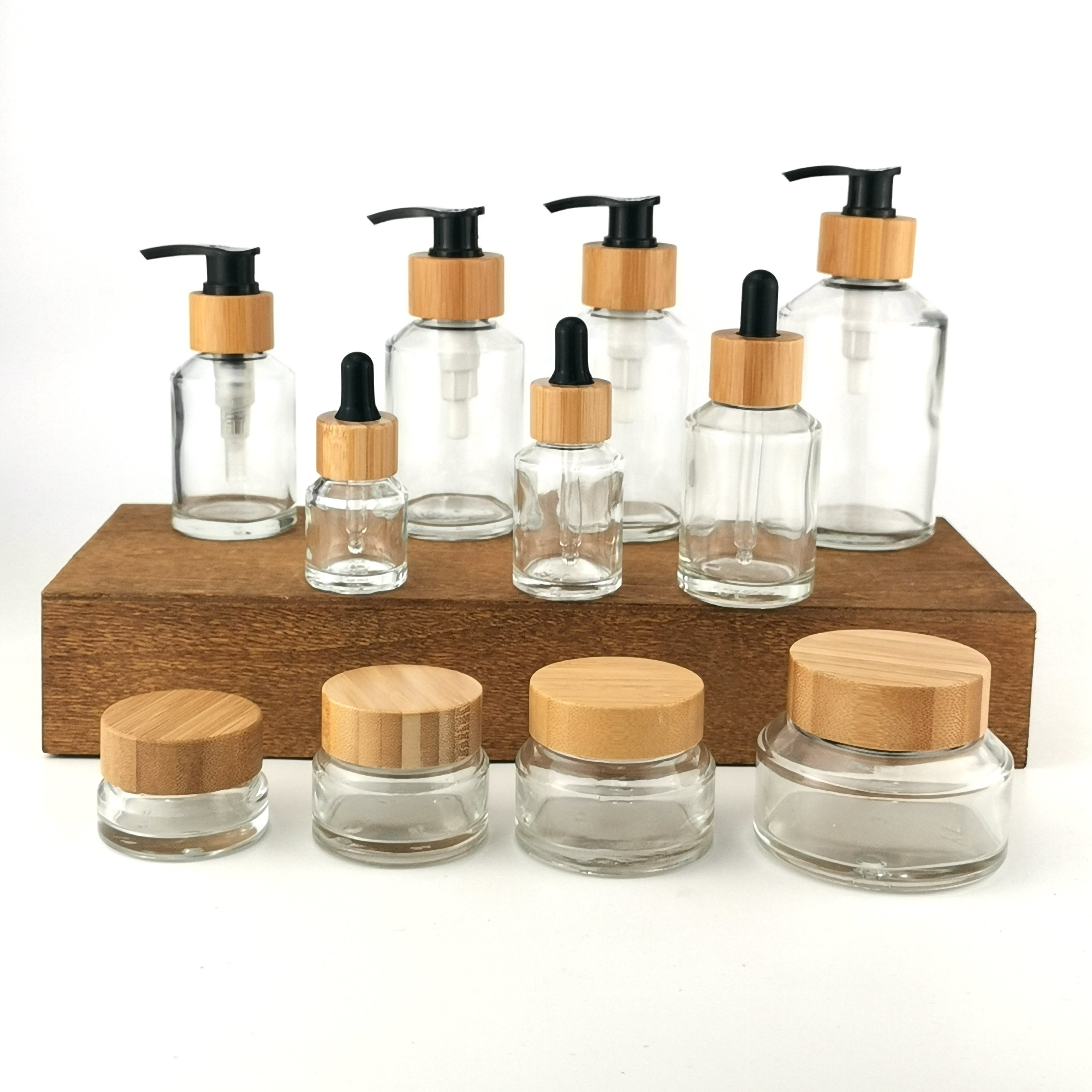 Inclined shoulder clear glass bottle 15 ml 30 ml 60 ml 100 ml 120 ml 200 ml and 15 g 30 g 50 g 100 g glass jar with bamboo lid