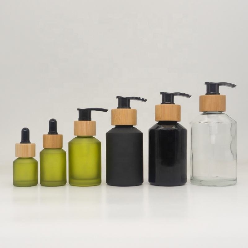 Cosmetic packaging slant shoulder matte black skin care set glass bottle cosmetic products with black dropper and jar with lid