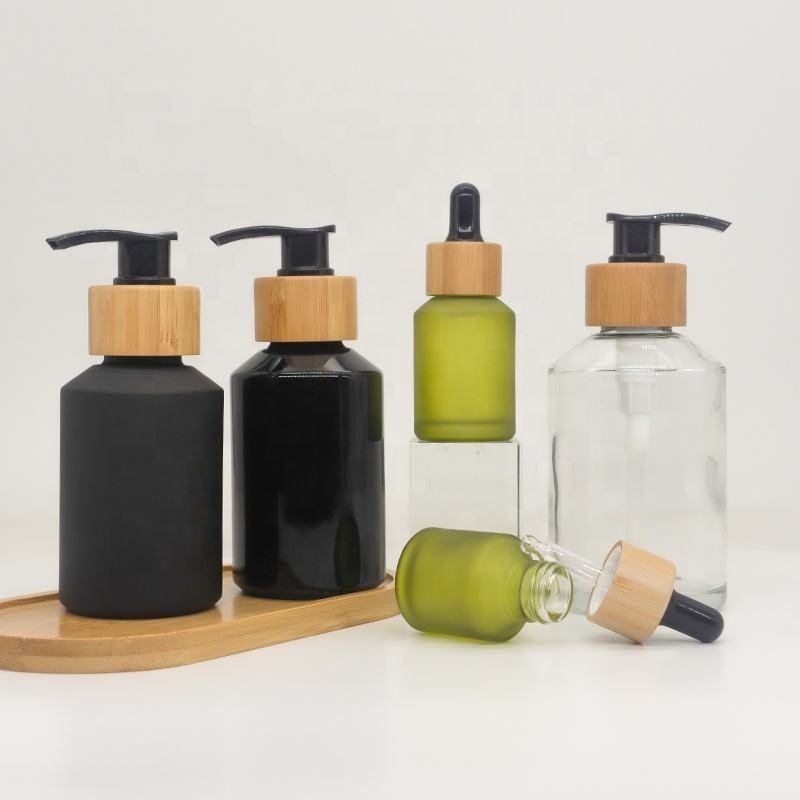 Cosmetic packaging slant shoulder matte black skin care set glass bottle cosmetic products with black dropper and jar with lid