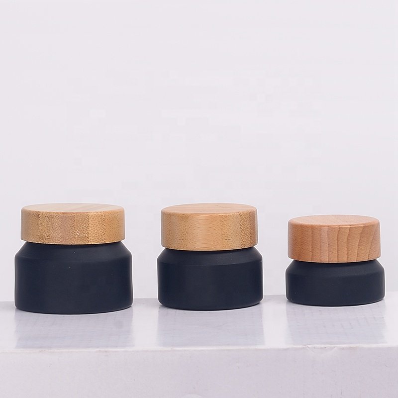 Inclined shoulder matte black glass bottle 30 ml 60 ml 100 ml cosmetic bottle and 15 gm 30 gm 50 gm glass jar with bamboo lid