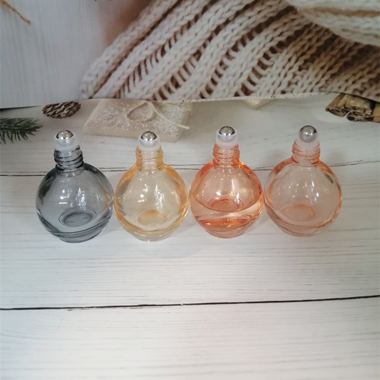 10ml pink/orange/grey/blue colored roll on bottle with gold lid