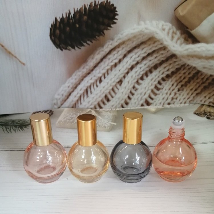 10ml pink/orange/grey/blue colored roll on bottle with gold lid