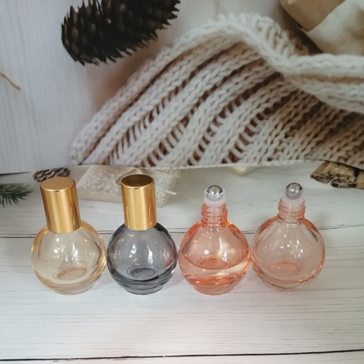 10ml pink/orange/grey/blue colored roll on bottle with gold lid