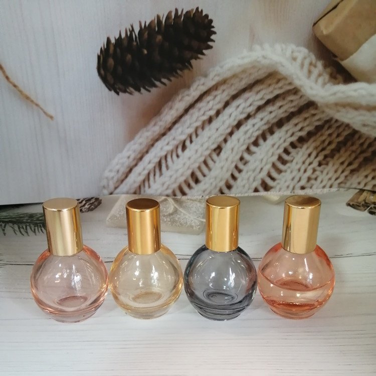 10ml pink/orange/grey/blue colored roll on bottle with gold lid