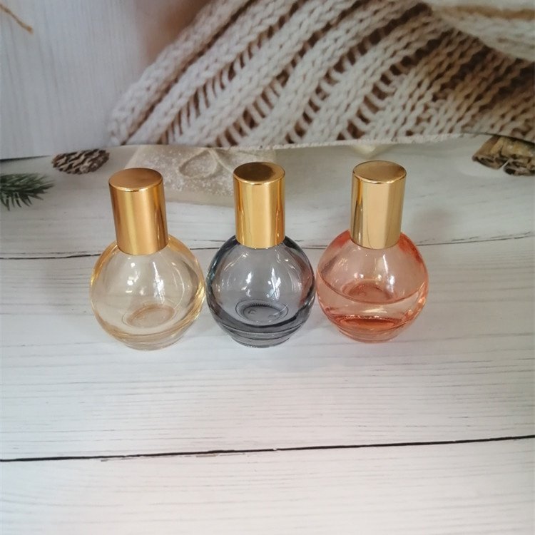 10ml pink/orange/grey/blue colored roll on bottle with gold lid