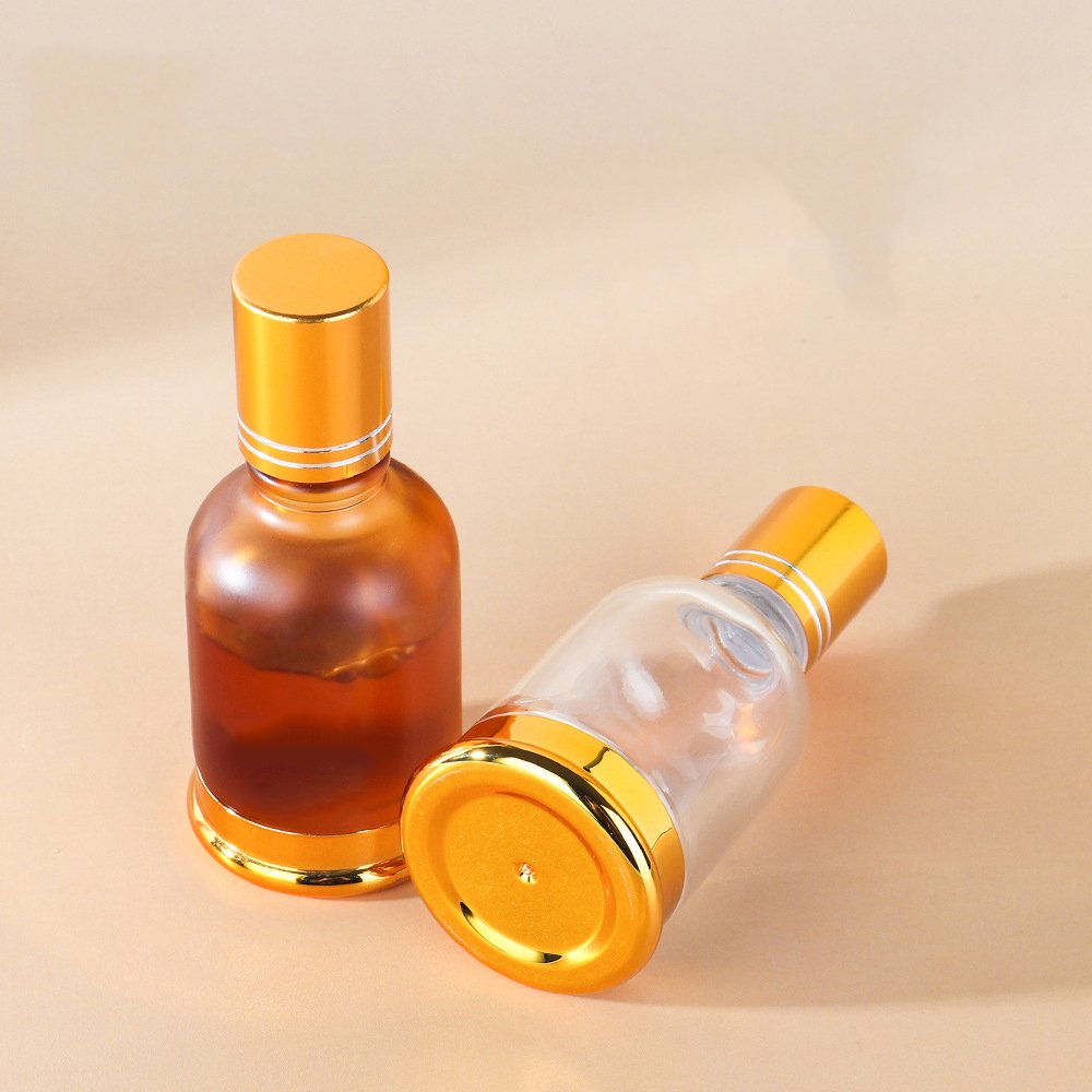 Luxury 20ml 30ml 50ml round clear amber roll on glass bottle with metal glass roller gloden cap bottle for perfume essential oil