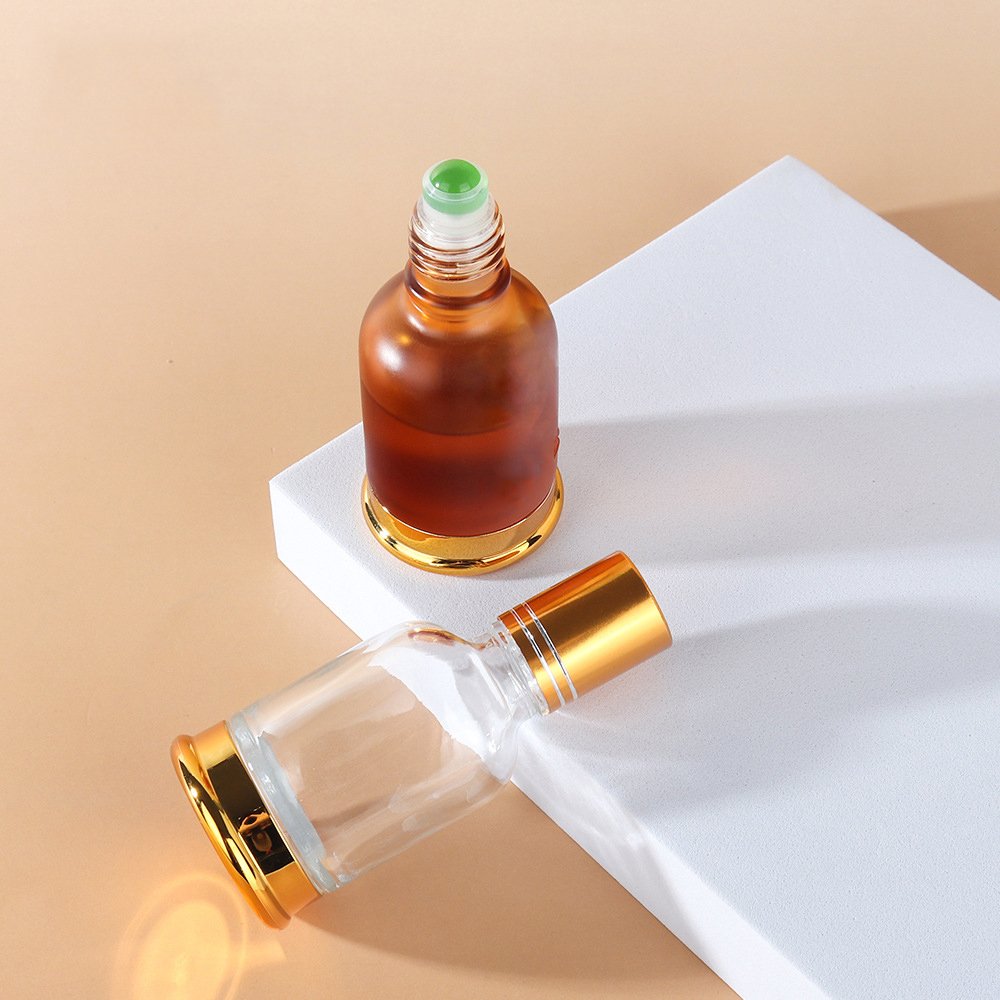 Luxury 20ml 30ml 50ml round clear amber roll on glass bottle with metal glass roller gloden cap bottle for perfume essential oil