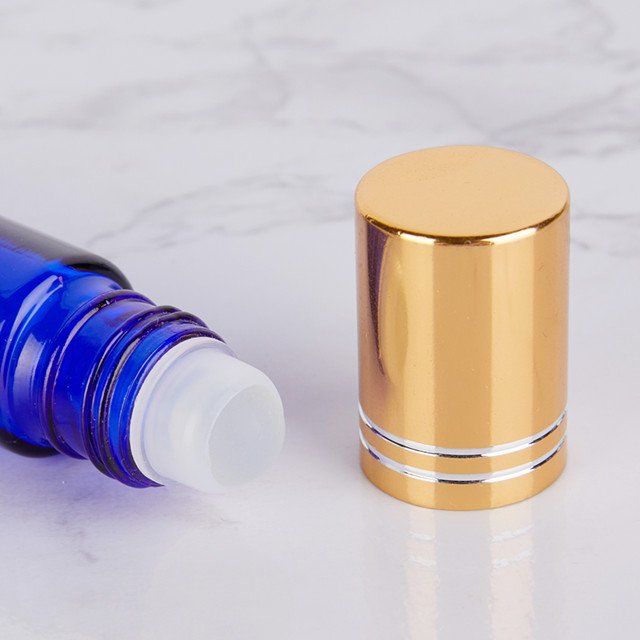 empty blue 10ml glass roller ball bottles for essential oils And the gold, silver, black and white lid