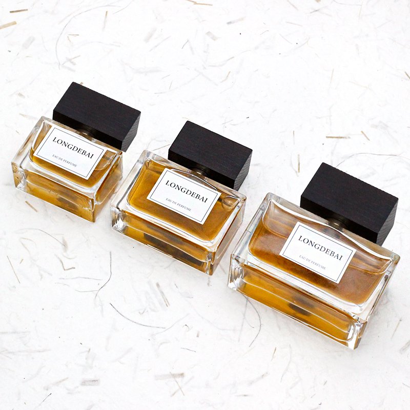 Wholesale empty unisex flat perfume glass bottle 30ml 50ml 100ml crimp perfume bottle with wooden cap