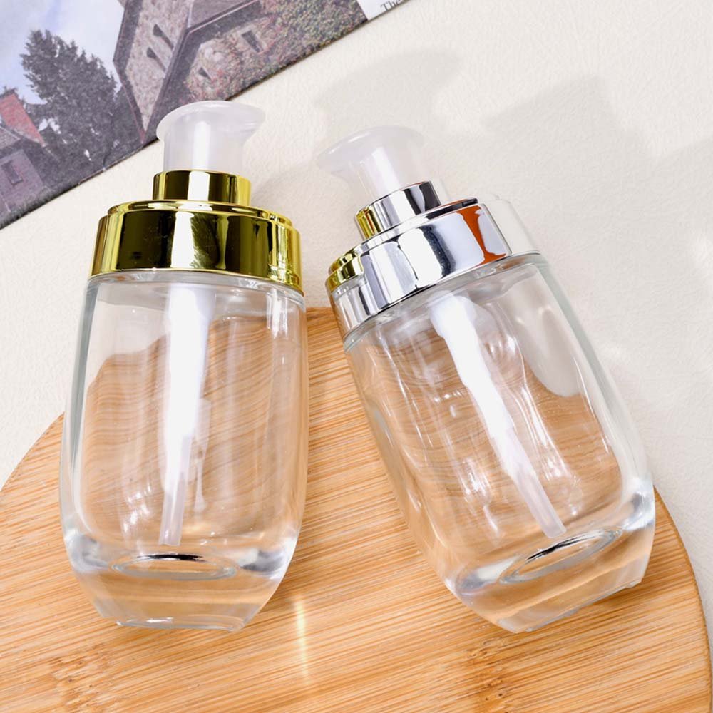 Customized Luxury cosmetic 30ml 50ml clear glass serum lotion bottle with pump lids