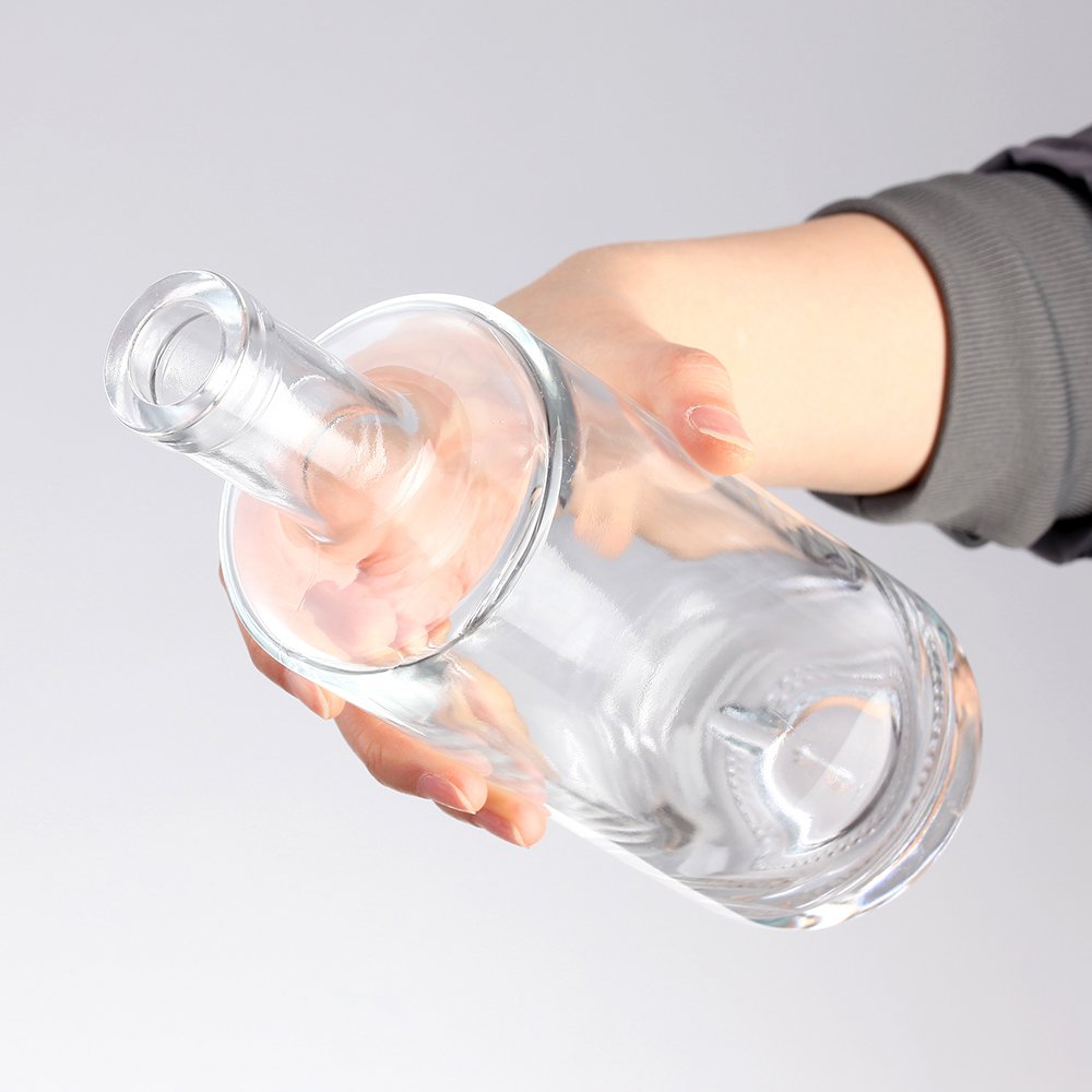 Custom 700ml 750ml embossed clear whiskey vodka tequila gin rum brandy glass bottle with synthetic cork