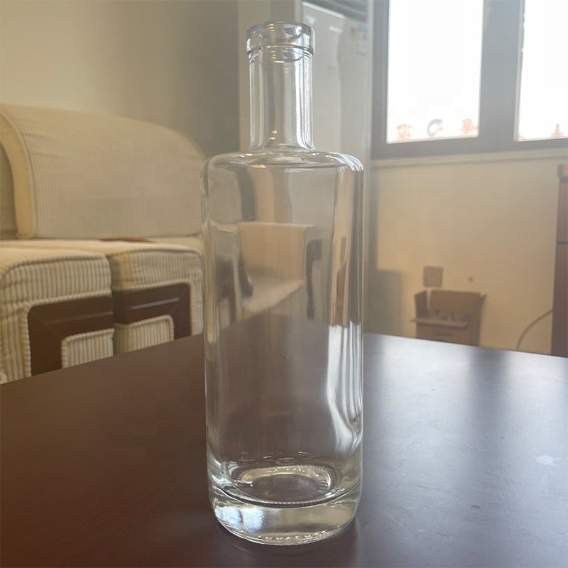 Custom 700ml 750ml embossed clear whiskey vodka tequila gin rum brandy glass bottle with synthetic cork