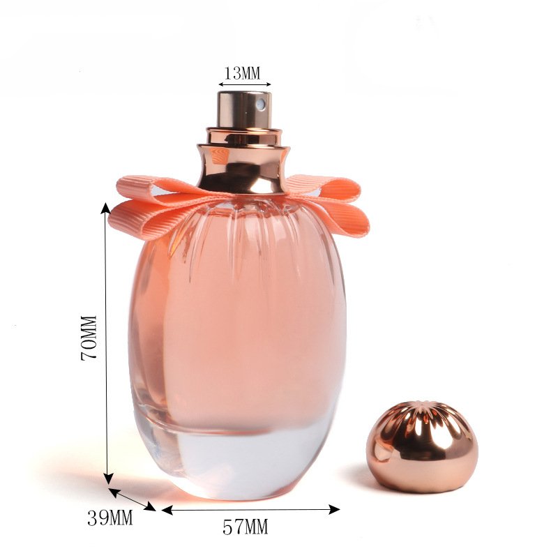 Hot selling round transparent golden cap pink bowknot luxury customized 100ml perfume glass spray bottle with lid