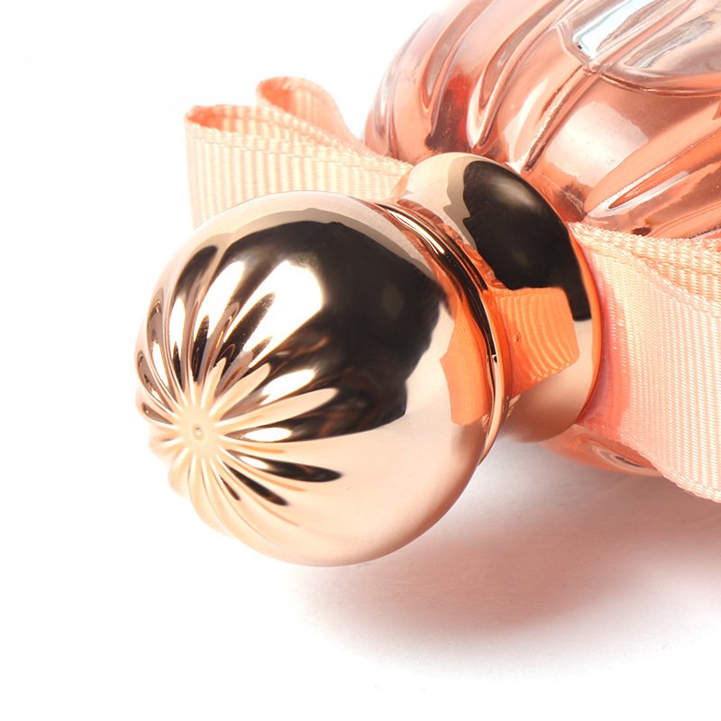 Hot selling round transparent golden cap pink bowknot luxury customized 100ml perfume glass spray bottle with lid