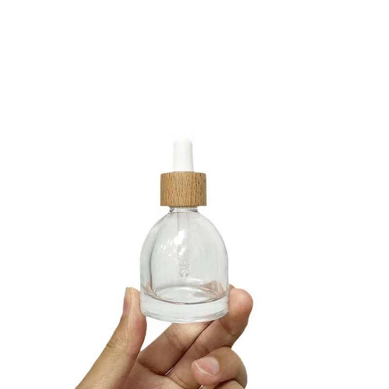 Manufacturer's creative 30ml transparent shaped oblique round dropper bottle for camellia oil screw mouth glass bottle wholesale