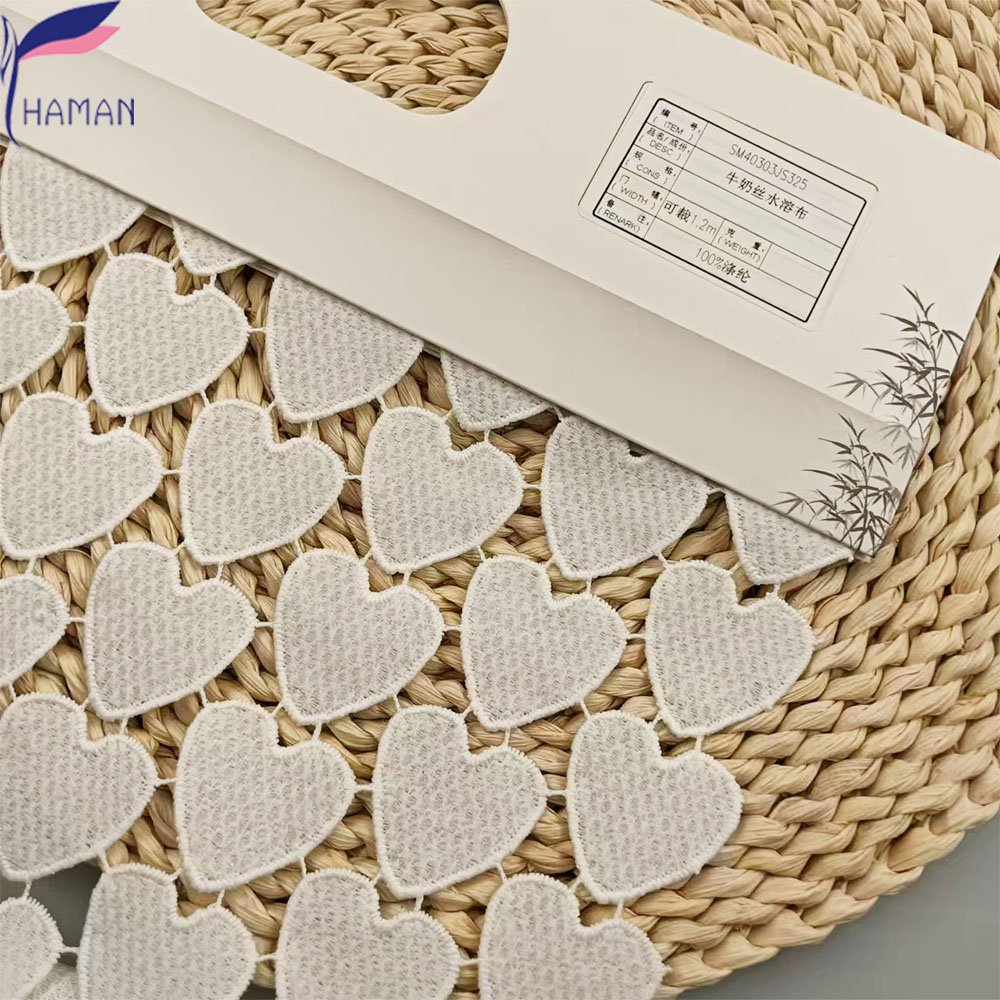 Exquisite hollow love pattern 100% polyester milk silk embroidery fabric for clothing and wallpaper