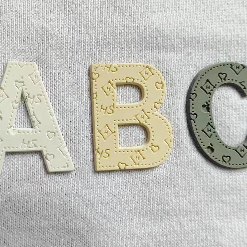 Wholesale customized letter pattern combination garment logo heat transfer silicone 3D relief grinding tool label for T-shirts