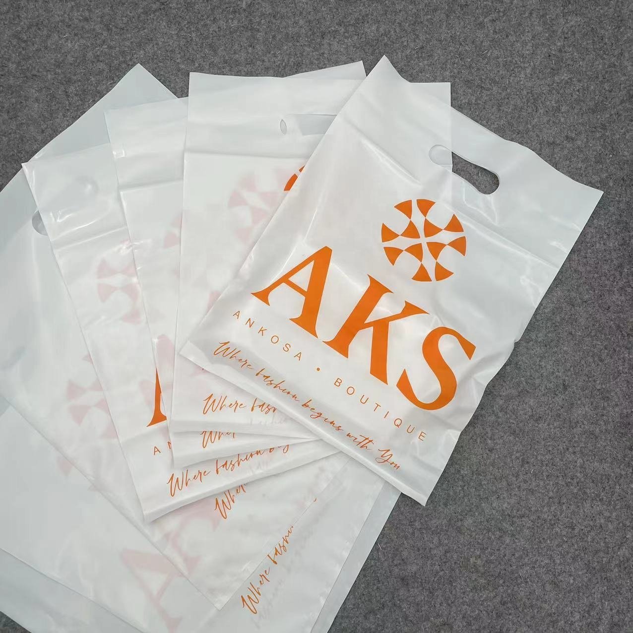 Wholesale Eco-friendly Recyclable Custom Logo Printed Die Cut Handle Plastic Packaging Shopping Bag For Clothing and Shoes