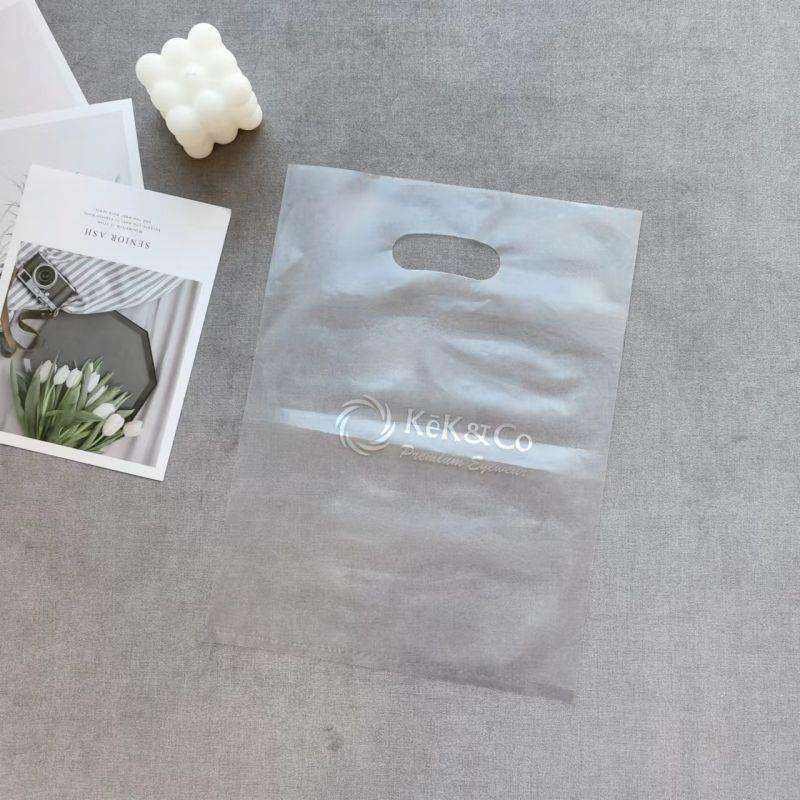 Custom Bags With Logo Plastic Waterproof Cloth Retail Pink Shopping Bag Luxury Printed Die Cut Plastic Shopping Bag With Handle