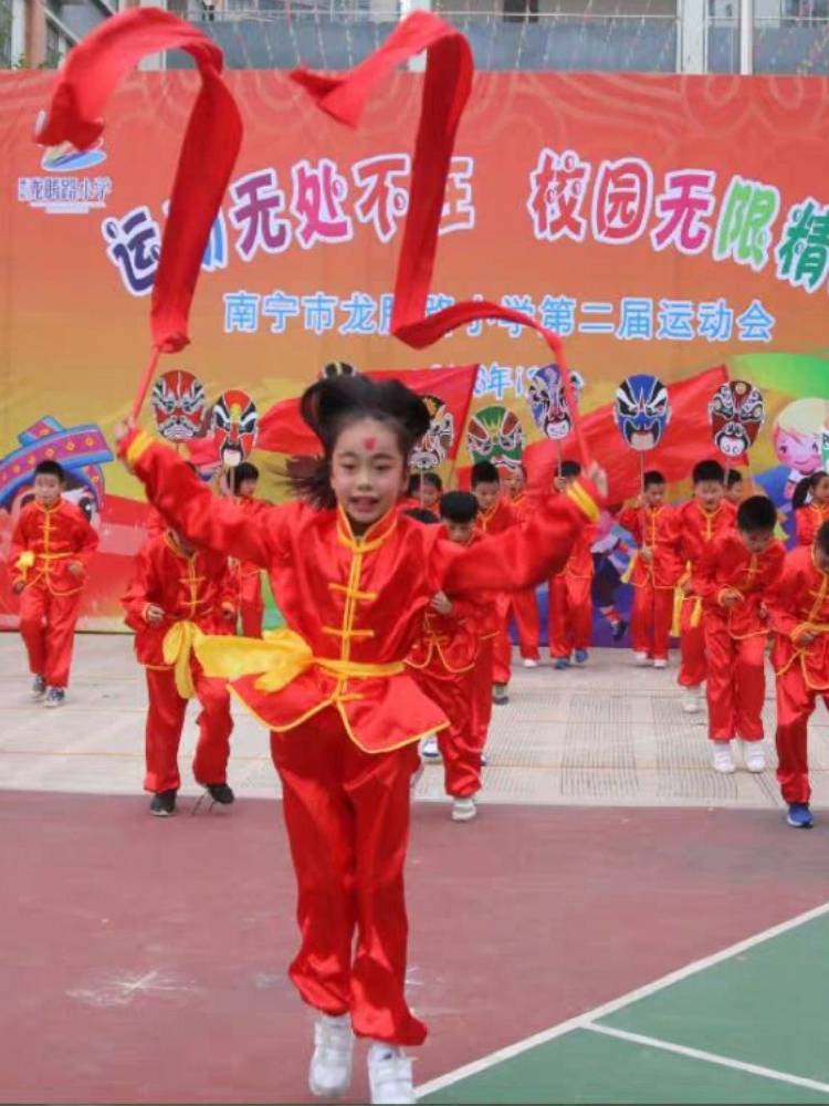 A pair of inter-curricular dance performances for a kindergarten with a child gymnasium ribbon with a wooden stick and a stick