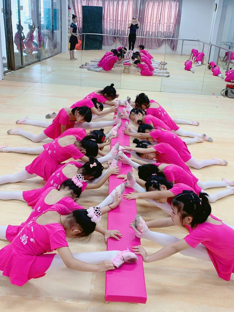 The factory's straight-up choreographer dances the leg and gymnastics stools
