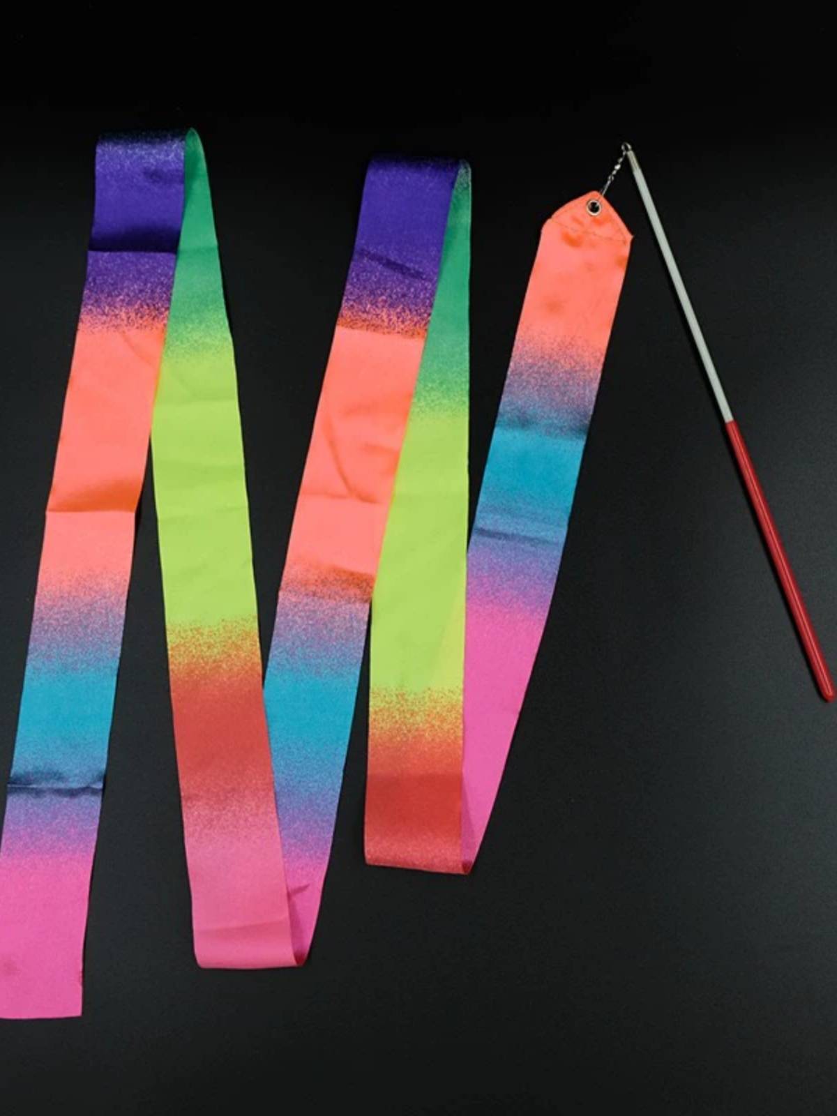 Promising gymnasium choreographer dances with sparkling silk and a professional ribbon with poles for adult children's stage shows