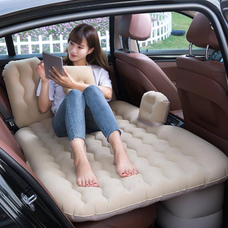A car with a pneumatic mattress in the back of the car with a pedestal