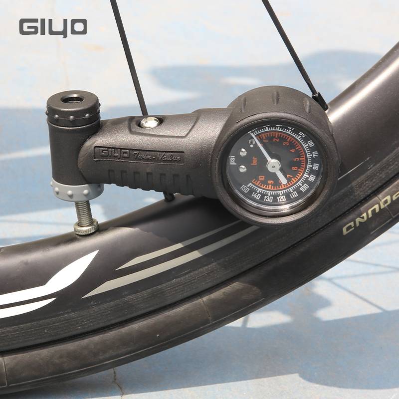 TAIWAN GIYO BICYCLE TIRES ON A MOUNTAIN ROAD, A PSALM OF TIRE PRESSURE GAUGES INSIDE THE TIRES