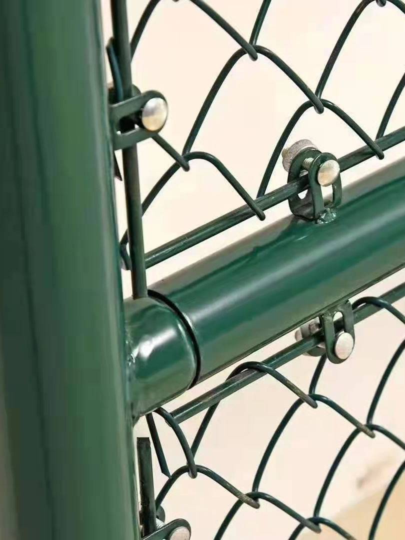 Green barbed wire tennis court in a sports field fenced on the net stadium