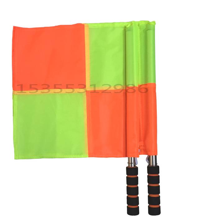 The referee uses a red and yellow card to pick the edges and cut the flags