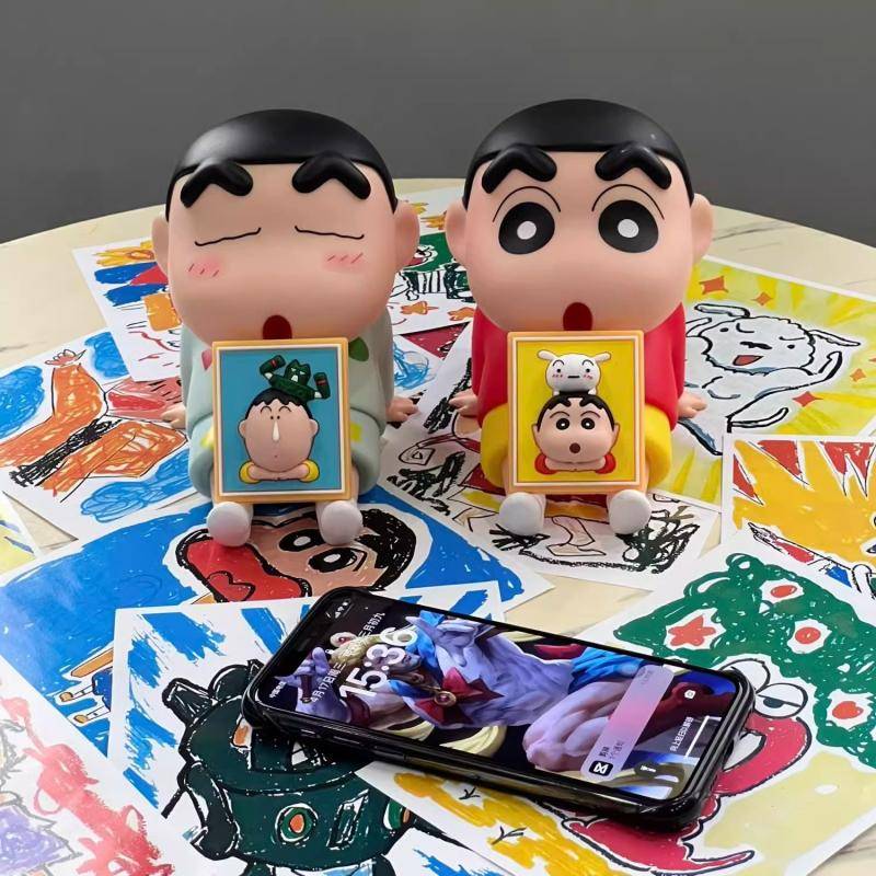 A crayon, a new phone with a lazy cell phone, a cute table setup with a hand-made model doll to play a strawberry bear