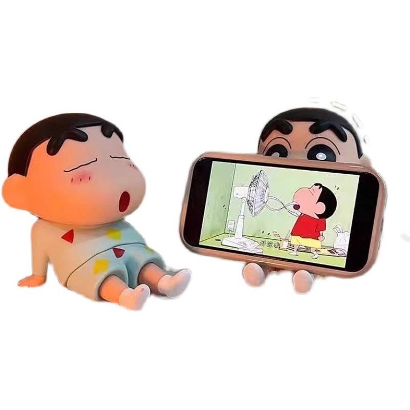 A crayon, a new phone with a lazy cell phone, a cute table setup with a hand-made model doll to play a strawberry bear