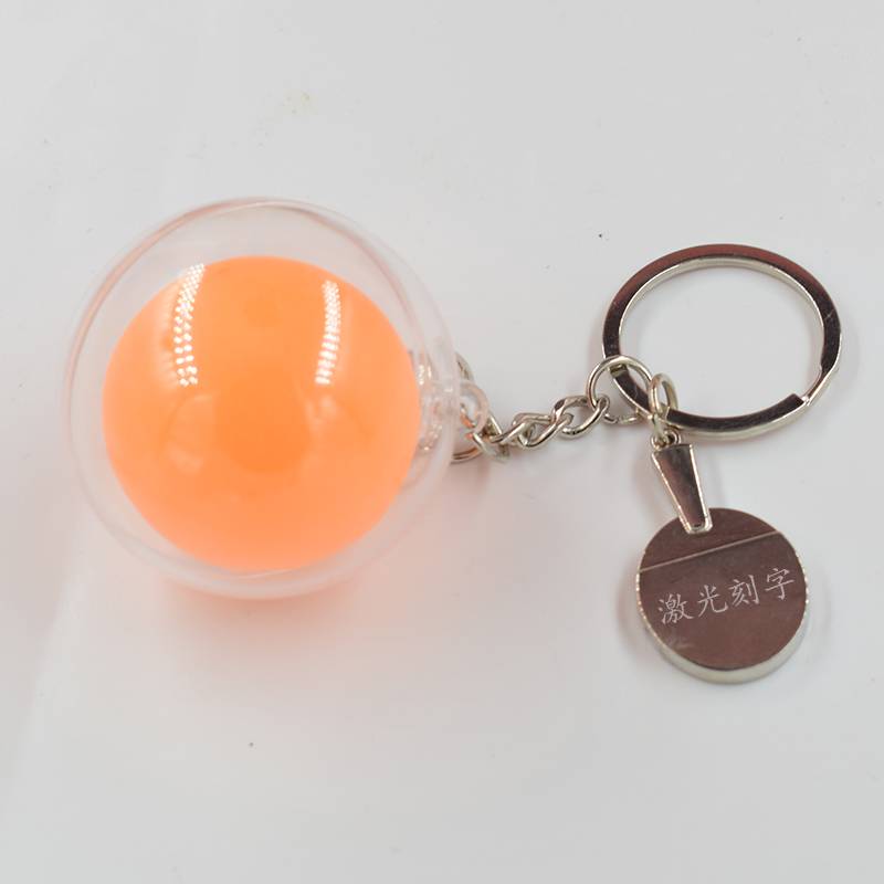 The racket keychain plus yellow table tennis lettering