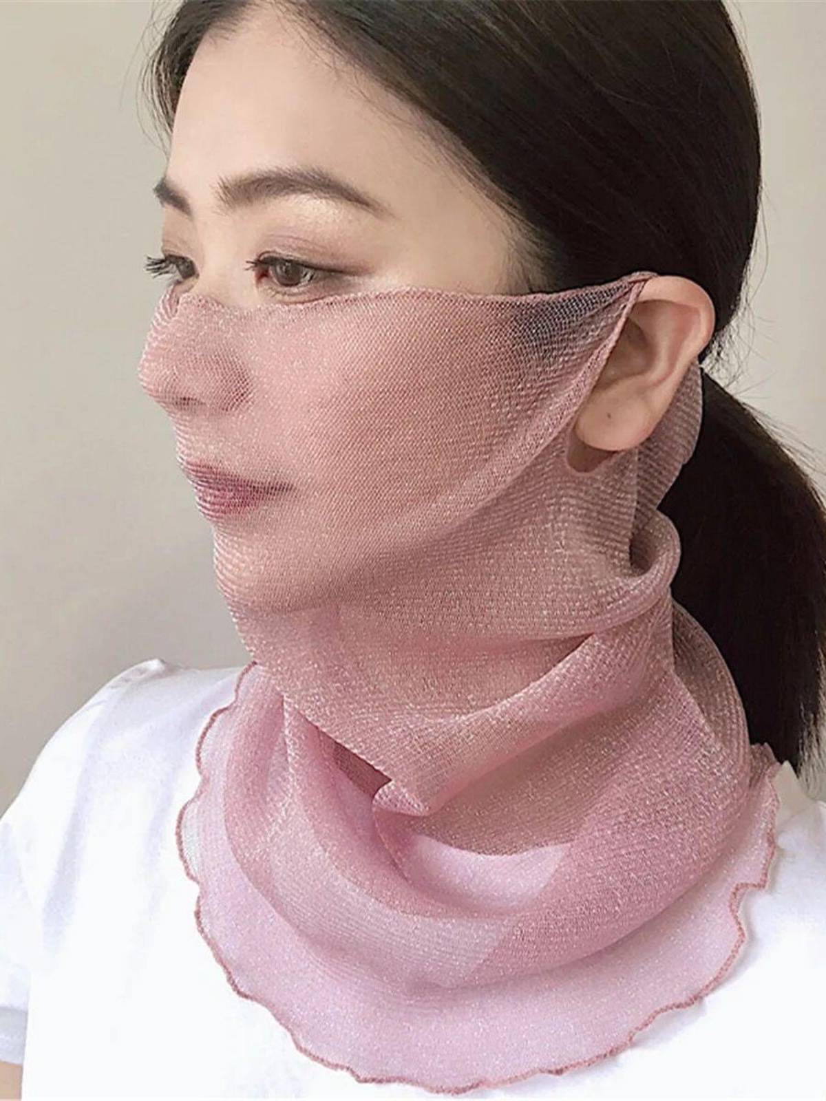 Golf sunscreen girl with a little turban on her ear with a white face on her tan mask