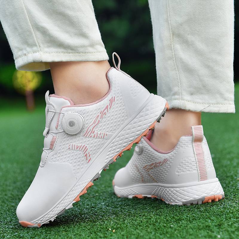 The new lady rotates the golf shoes outside of the house