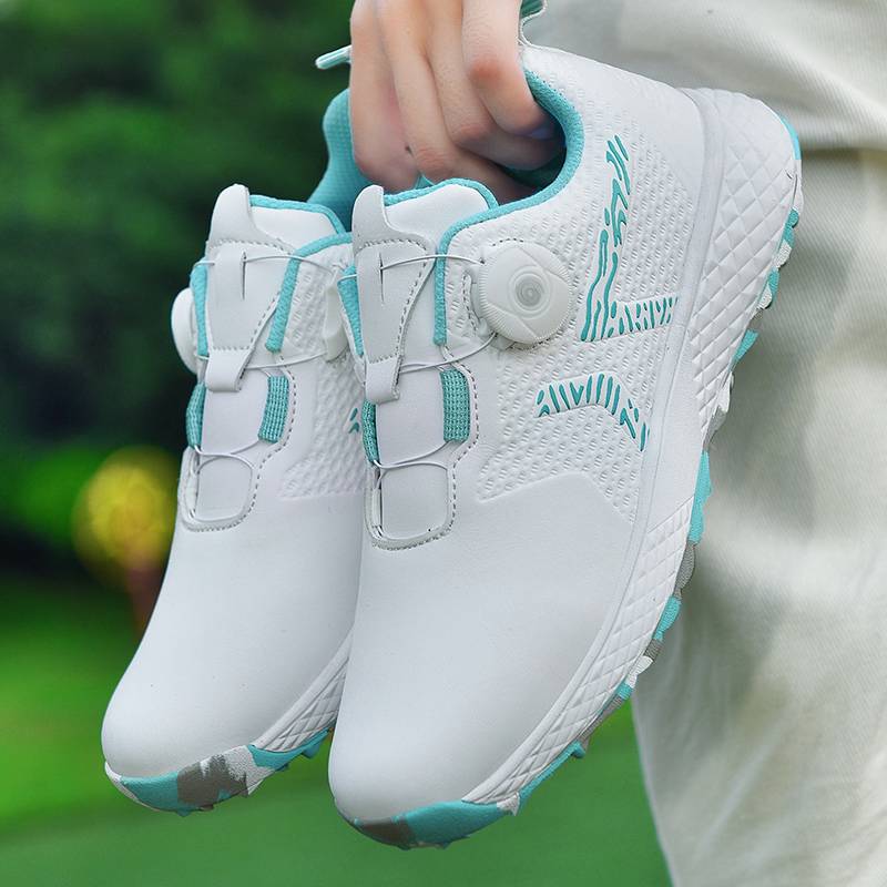 The new lady rotates the golf shoes outside of the house