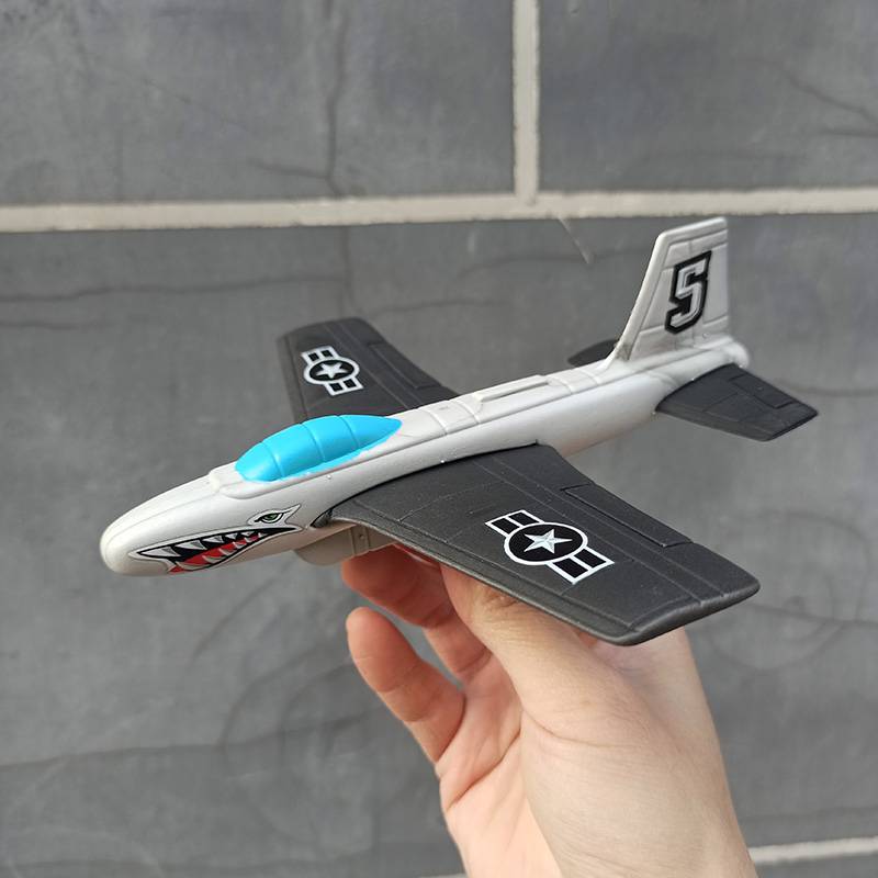 Gray -white hand throwing small plane