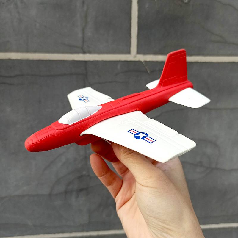 Red and white hand throw small plane