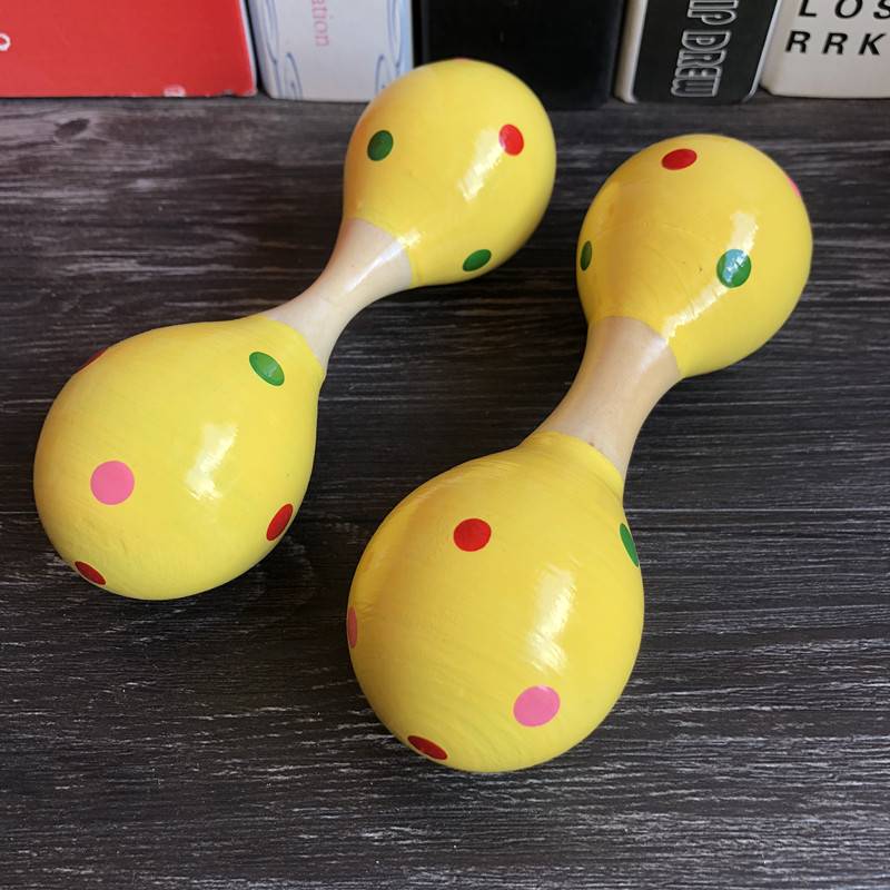 Two small yellow double -headed sand balls
