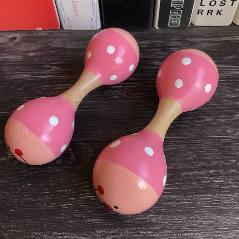 Two pink double -headed sand balls
