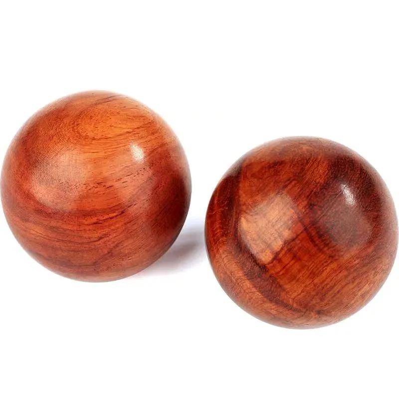 Rosewood handball player playing with fingers flexibly holding the ball and playing with a rehabilitation training fitness ball natural health ball