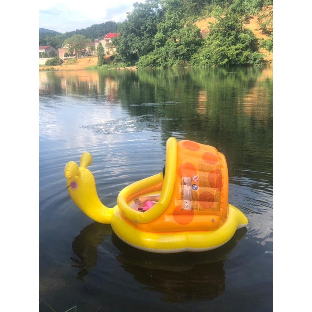 Surfing on a water surfing toy, children on a seaside swimming ring, children and young children on a floating bed inflatable band
