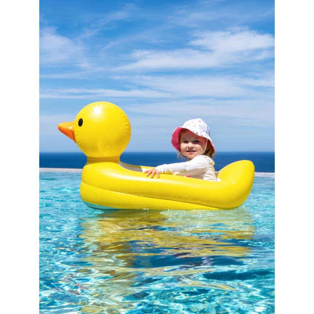 Surfing on a water surfing toy, children on a seaside swimming ring, children and young children on a floating bed inflatable band