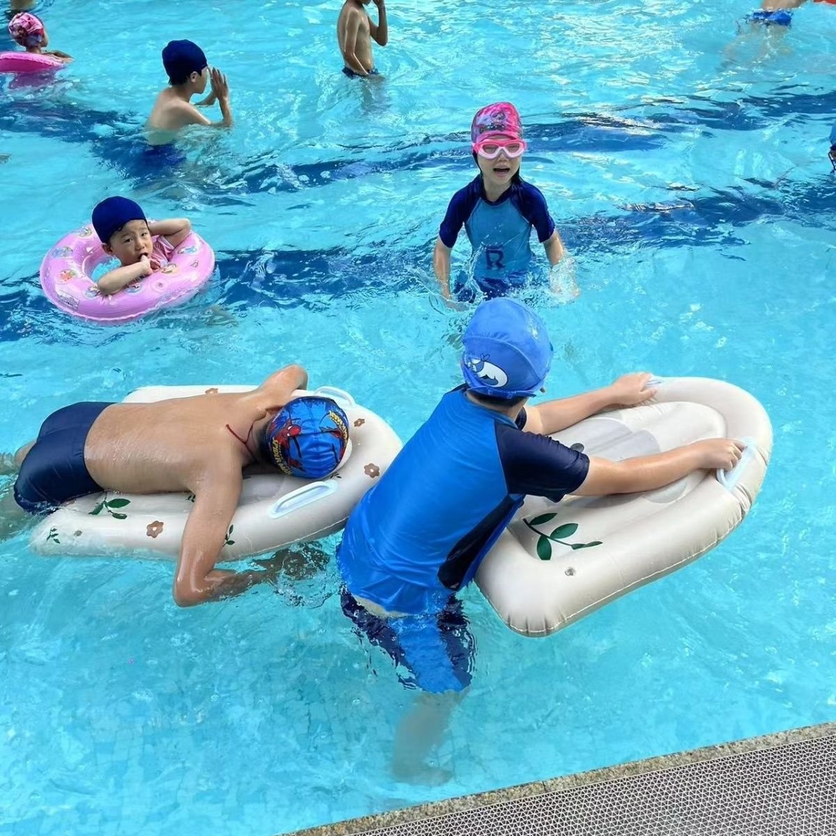 Children's surfboard floats are inflating and swimming by the sea
