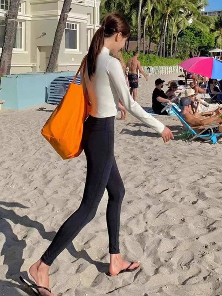 The white part, long-sleeve surfsuit, the new girl in the swimsuit