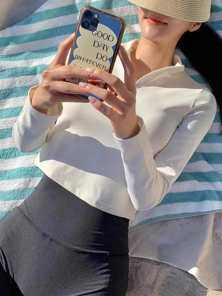 The white part, long-sleeve surfsuit, the new girl in the swimsuit